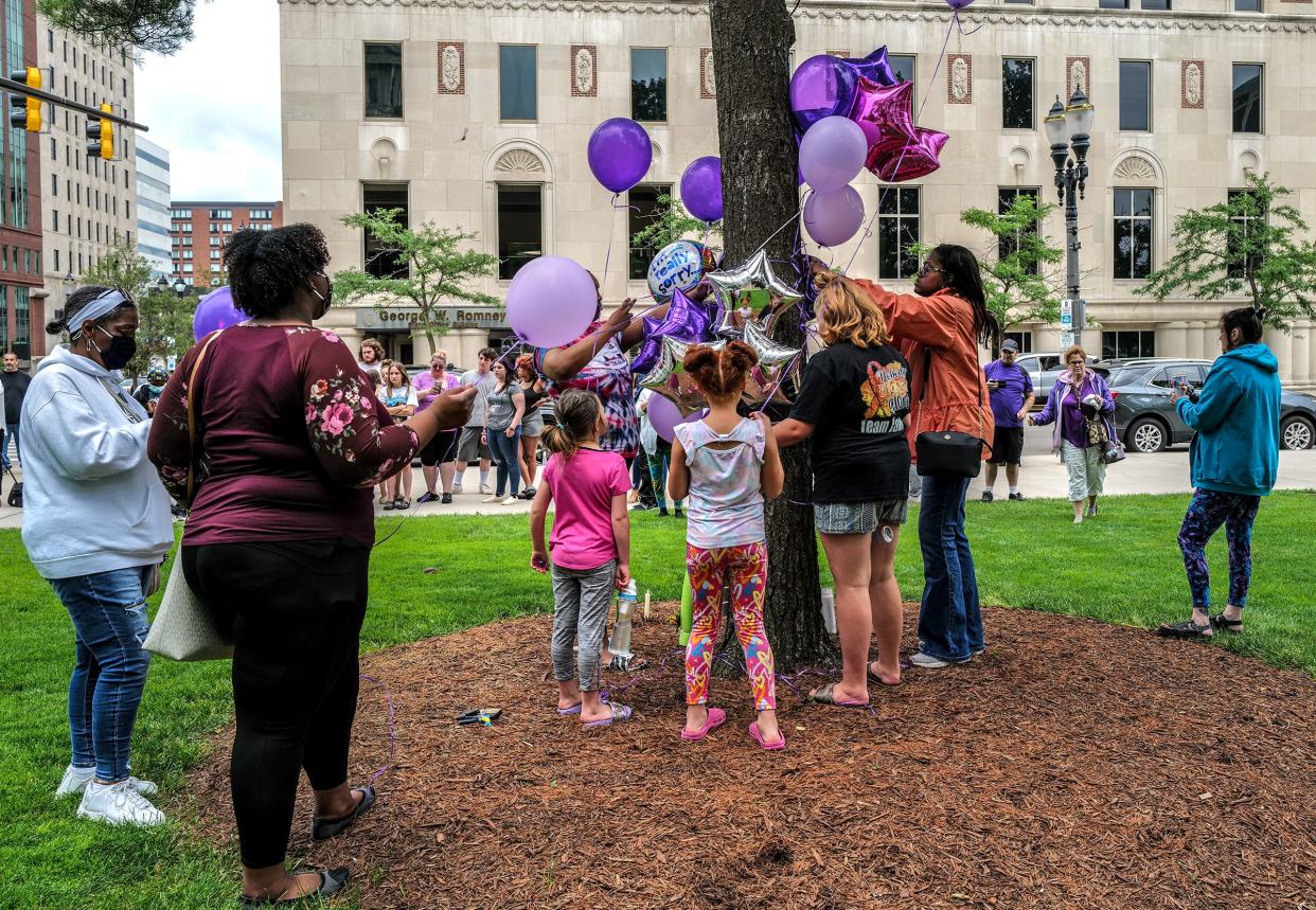 People gather and construct a memorial to honor 2-year-old Wynter Cole-Smith on the Capitol lawn Saturday, July 8, 2023.