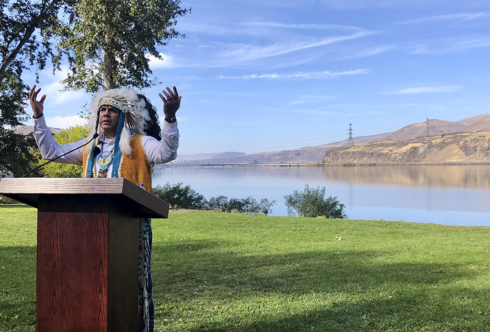 JoDe Goudy, chairman of the Yakama Nation, speaks with the Columbia River in the background near The Dalles, Oregon, on Monday, Oct. 14, 2019, where Celilo Falls, an ancient salmon fishing site was destroyed by the construction of the Dalles Dam in the 1950s. (AP Photo/Gillian Flaccus)