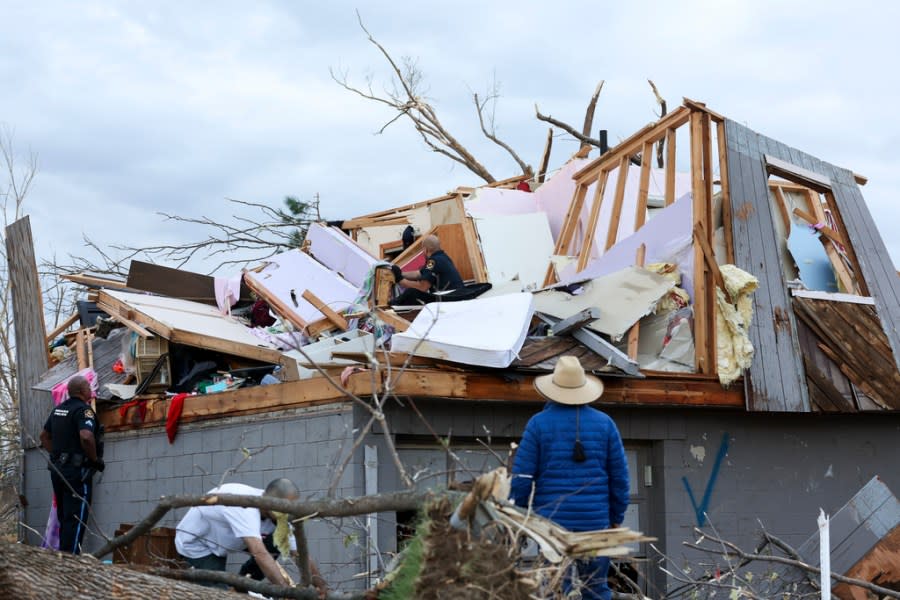 Omaha police officers search a home for a family after a tornado leveled dozens of homes near Omaha, Neb., on Friday, April 26, 2024. (Nikos Frazier/Omaha World-Herald via AP)