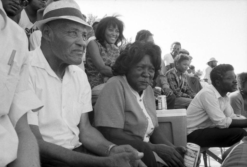 James Milligan, 81, and Eula Milligan, 77, watch a championship softball game with their children and grandchildren at Sycamore Park in Fort Worth as part of Juneteenth festivities in 1977.