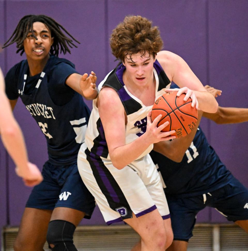 Nate Reynolds of Bourne grabs a rebound from Ethan Jarrett of Nantucket.