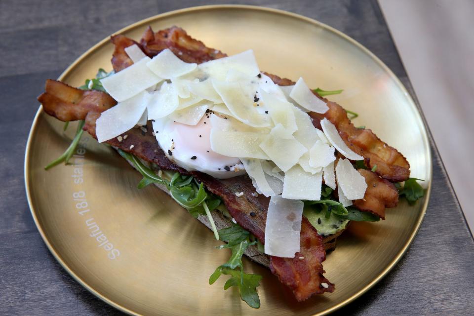 Toast with avocado, arugula salad, bacon, an egg and parmesan at D'Amore's Caffe and Toast in Wall.