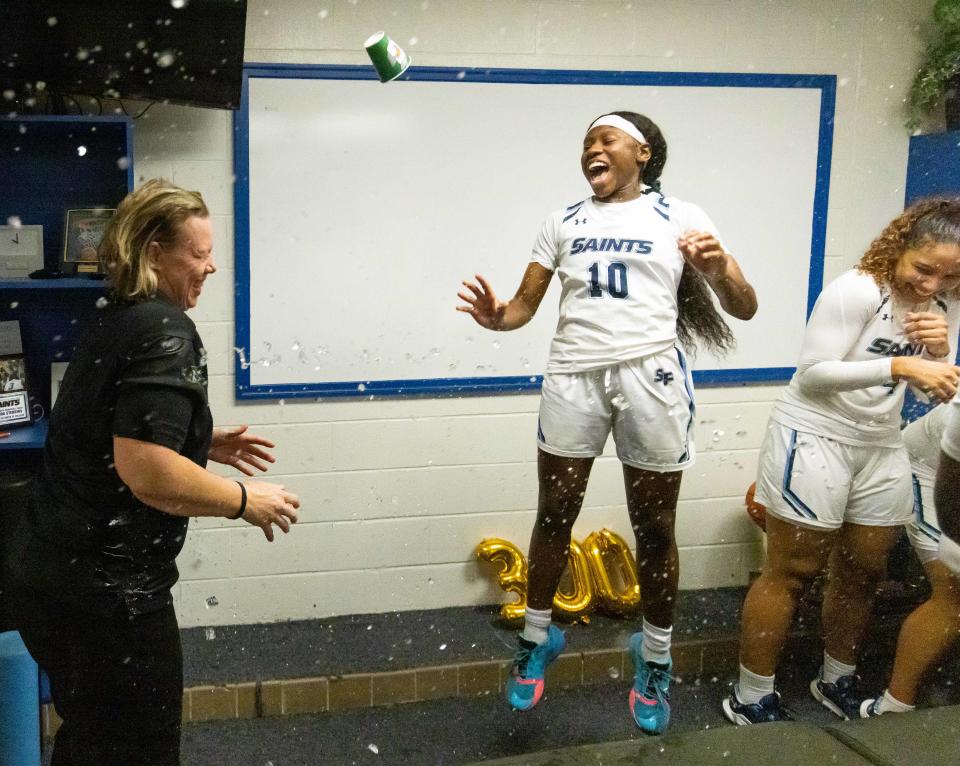 Santa Fe College head coach Chanda Stebbins gets doused with water in the locker room from her teammates after earning her 300th win Wednesday night. Santa Fe College hosted Florida State College at Jacksonville Wednesday January 25, 2023 at Santa Fe  College in Gainesville, FL. Santa Fe won 59-54. [Doug Engle/Ocala Star-Banner]2023