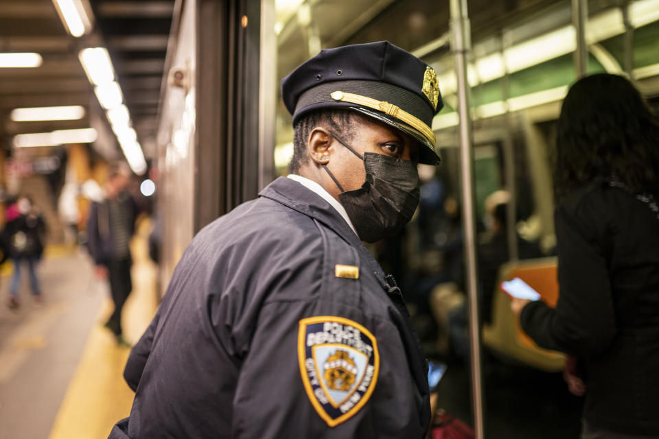 NYPD officers patrol platforms and train cars at the 36th Street subway station where a shooting attack occurred the previous day during the morning commute, Wednesday, April 13, 2022, in New York. Mayor Eric Adams said Wednesday that officials were now seeking 62-year-old Frank R. James as a suspect. (AP Photo/John Minchillo)