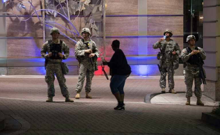 Members of the National Guard stand guard in front of a luxury hotel in Charlotte, North Carolina, where the police shooting of Keith Lamont Scott caused several nights of unrest