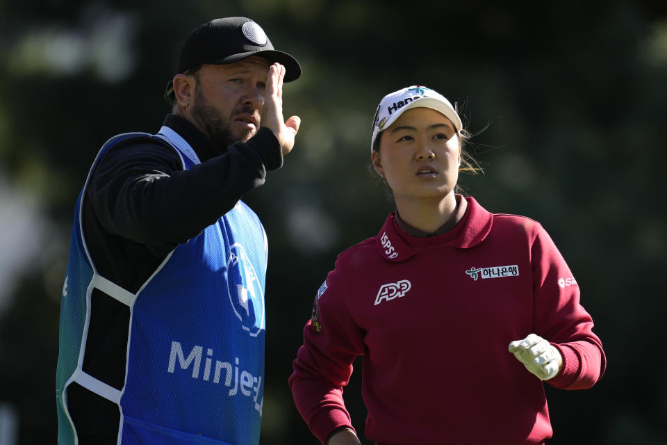 Minjee Lee of Australia talks with her caddie during the second round of the BMW Ladies Championship at the Seowon Hills Country Club in Paju, South Korea, Friday, Oct. 20, 2023. (AP Photo/Lee Jin-man)