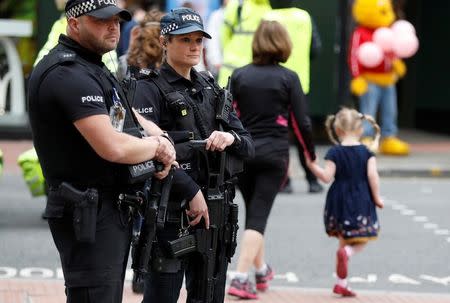 Armed police officers stand on duty in central Manchester, Britain, May 28, 2017. REUTERS/Phil Noble