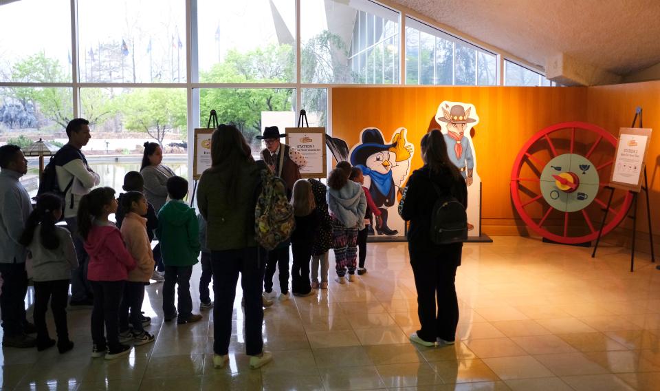 Michael Grauer, McCasland Chair of Cowboy Culture and Curator of Cowboy Collections and Western Art at the National Cowboy & Western Heritage Museum, talks to members of the media about the exhibit "Playing Cowboy" Friday, March 24, 2023, in Oklahoma City. "Playing Cowboy" features Western books, games and toys for children.