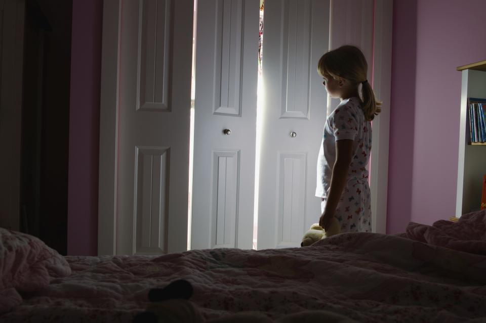 Young girl scared in bedroom