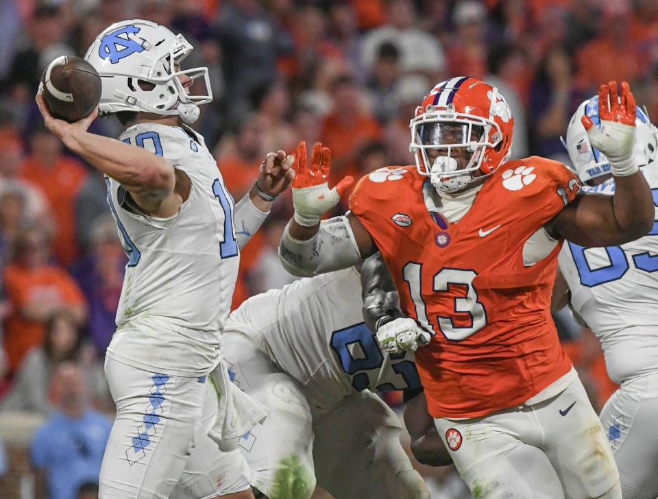 Clemson defensive tackle Tyler Davis (13) pursues North Carolina quarterback Drake Maye (10) during a November game.