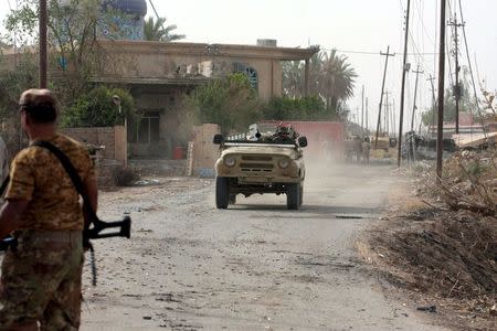 A military vehicle is seen in Baiji, north of Baghdad, July 2, 2015. REUTERS/Mushtaq Muhammed