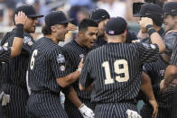 Vanderbilt's Jayson Gonzalez, center, celebrates with teammates as he returns to the dugout after hitting a two-run home run against Arizona in the fifth inning during a baseball game in the College World Series, Saturday, June 19, 2021, at TD Ameritrade Park in Omaha, Neb. (AP Photo/Rebecca S. Gratz)