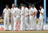 Australian team gathers to watch results of a review as West Indies batsman Carlton Baugh was caught lbw during the fourth day of the second-of-three Test matches between Australia and West Indies April 18, 2012 at Queen's Park Oval in Port of Spain, Trinidad.