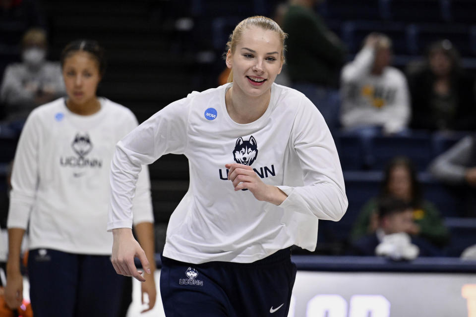 UConn's Dorka Juhasz (14) warms up before a second-round college basketball game against Baylor in the NCAA Tournamen in Storrs, Conn., March 20, 2023. Juhasz is among players headed to the draft. Even the handful of players selected in the upcoming WNBA draft will find it difficult to continue their pro careers. (AP Photo/Jessica Hill)