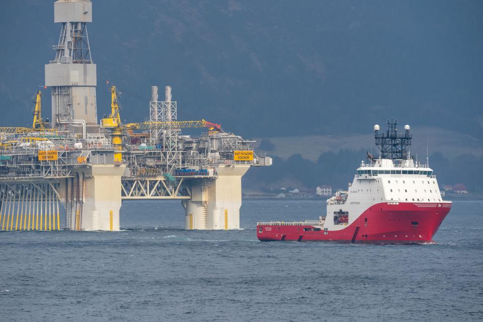 Rig move of Equinor oil platform Njord Alpha with ahts vessels Siem Pearl inside the Norwegian fjord Breisund.