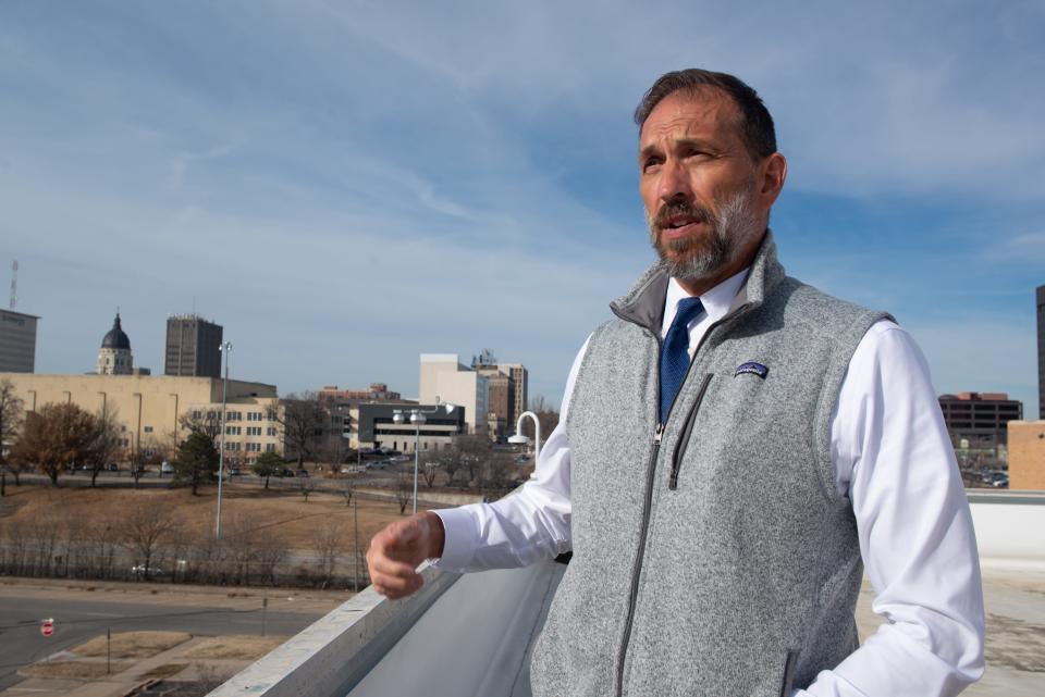 Standing atop the roof of the city of Topeka's Holliday Building, recently retired city planning and development director Bill Fiander talks about how, as part of his duties, he walked the various blocks in Topeka to gain a better sense of place.