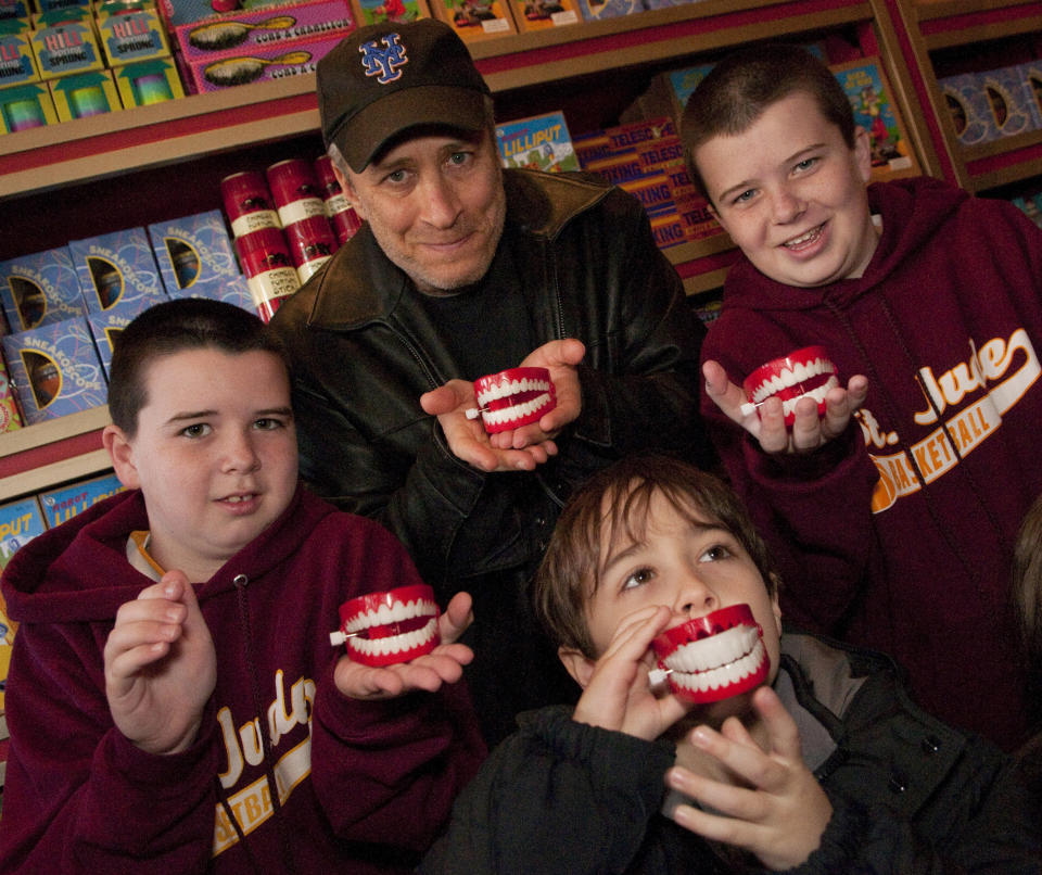 ORLANDO, FL - FEBRUARY 08:  In this handout photo provided by Universal Orlando Resort, Jon Stewart, comedian, political satirist and Emmy-award winning TV show host, stopped to clown around with family (nephews Gavin, 9, (left) and Colin, 12, (right) and son Nate, 6 (front)) while visiting Zonkos joke shop at The Wizarding World of Harry Potter at Universal Orlando Resort on February 8, 2011 in Orlando, Florida.  Best known as the host of Comedy Central's 'The Daily Show', Stewart and his family were invited to tour the highly-acclaimed new theme park environment while on vacation, stopping to enjoy Butterbeer and do some shopping at Honeydukes sweet shop.  (Photo by Roberto Gonzalez/Universal Orlando Resort via Getty Images)