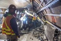 This May 19, 2019 photo provided by the Metropolitan Transportation Authority shows workers during the L Project subway tunnel rehabilitation, in New York. Eight years ago Thursday, Oct. 29, 2020, Superstorm Sandy pushed the Hudson River over its banks, sending 8 feet of water onto underground tracks and leaving the main waiting room unusable for months. New York's Metropolitan Transportation Authority, which serves several million riders daily on subways, trains and buses, had to repair damage to more than a dozen bridges and tunnels, many pre-dating World War II, caused by tens of millions of gallons of saltwater. (Trent Reeves/Metropolitan Transportation Authority via AP)