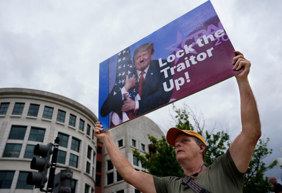 A protester holds up a sign.