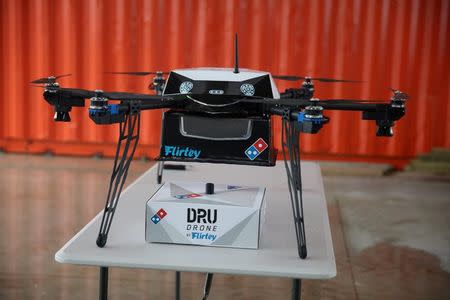 A pizza delivery drone sits with a pizza box underneath before a test flight in Auckland, New Zealand, August 25, 2016. Domino's/Handout via REUTERS