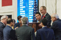 Senate President Mitch Carmichael, R-Jackson, speaks with other senators to work out a parliamentary question during debate in the state Senate chamber to amend an amended version of Senate Bill 451 passed by the House of Delegates at the West Virginia state Capitol in Charleston, W.V., Monday evening, Feb. 18, 2019. (Craig Hudson/Charleston Gazette-Mail via AP)