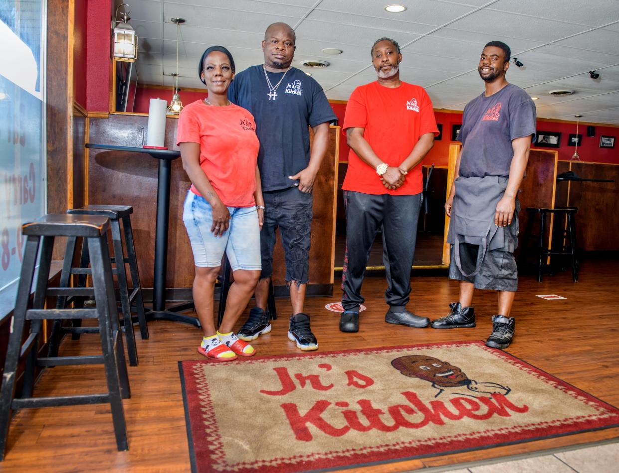 Elbert Nickerson Jr. and his wife Shelanda, left, run Jr's Kitchen with help from cooks Kevin Cockrill, right, and Danny Tillman at 1024 W. Main Street in Peoria and a second location at 123 MacArthur Highway.