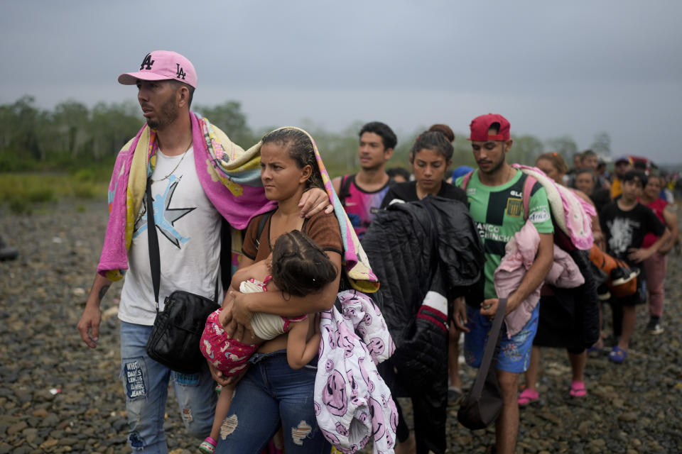 Migrants line up to take a boat after walking across the Darien Gap from Colombia, in Bajo Chiquito, Panama Sunday, May 7, 2023. (AP Photo/Natacha Pisarenko)