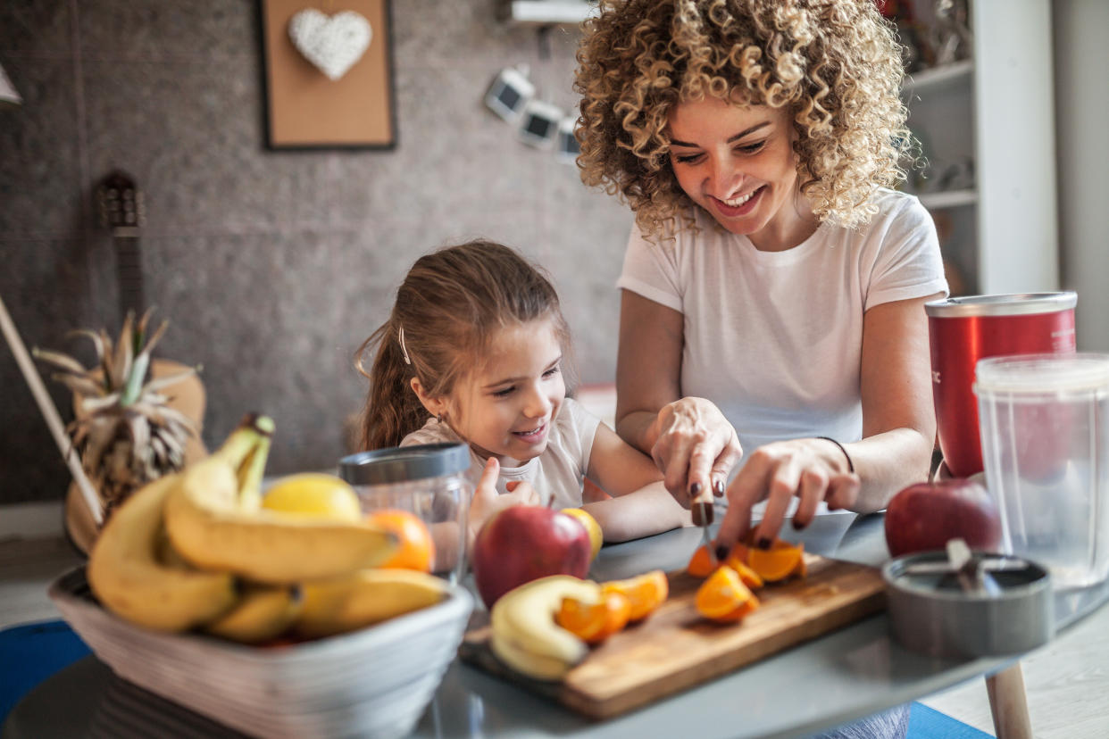 Mother and daughter making vegan smoothie. The vegan diet has become popular in recent years, but is it safe for infants and children? (Photo via Getty Images)