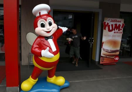 A Jollibee mascot is pictured at the entrance of a Jollibee franchise in Paranaque, Metro Manila, March 1, 2016. REUTERS/Erik De Castro/Files