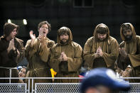 San Diego Padres fans dressed like friars cheer and hold their hands in prayer during the team's baseball game against the Miami Marlins, Friday, July 23, 2021, in Miami. (AP Photo/Lynne Sladky)