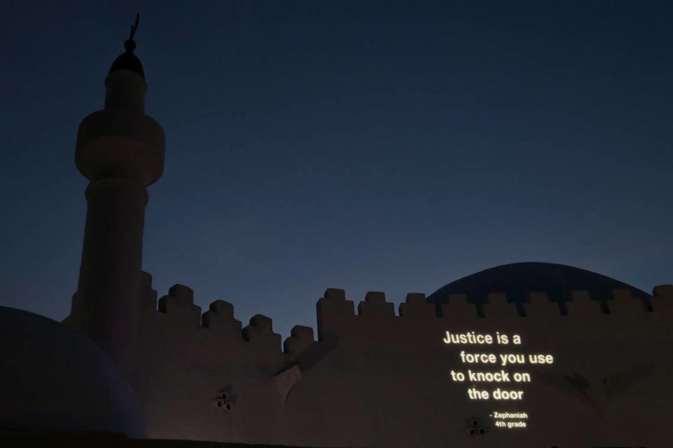 A poem written by fourth-grader Zephaniah is projected on the wall of the Hurt Building on the corner of Opa-locka Boulevard and Ali Baba Avenue as part of the Opa-Locka Light District project in the city of Opa-Locka, Florida, on Wednesday, July 21, 2021.