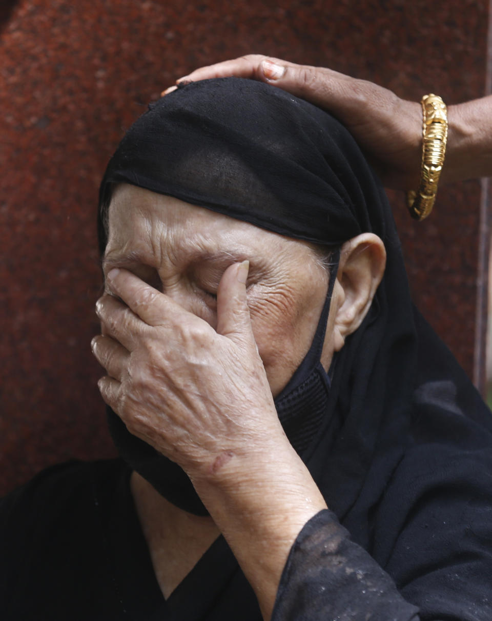 A relative of Bollywood icon Dilip Kumar mourns outside his house in Mumbai, India, Wednesday, July 7, 2021. Dilip Kumar, hailed as the "Tragedy King" and one of Hindi cinema's greatest actors, died Wednesday in a Mumbai hospital after a prolonged illness. He was 98. (AP Photo/Rafiq Maqbool)