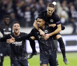 Frankfurt's scorer Sebastien Haller, center, Luka Jovic, left, and Mijat Gacinovic celebrate their side's second goal during the second leg, round of 32, Europa League soccer match between Eintracht Frankfurt and FC Shakhtar Donetsk, in Frankfurt, Germany, Thursday, Feb. 21, 2019. (AP Photo/Michael Probst)