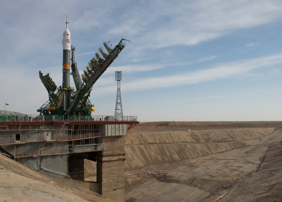 Large gantry mechanisms on either side of the Soyuz TMA-08M spacecraft are raised into position to secure the rocket at the launch pad on Tuesday, March 26, 2013 at the Baikonur Cosmodrome in Kazakhstan. Liftoff is set for March 28 EDT (March 2