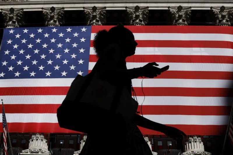 An American flag hangs outside at the entrance to the New York Stock Exchange on Wall Street on Wednesday in New York City. The S&P 500 and Nasdaq closed at fresh record highs in a shortened trade day before the 4th Of July Holiday. Photo by John Angelillo/UPI