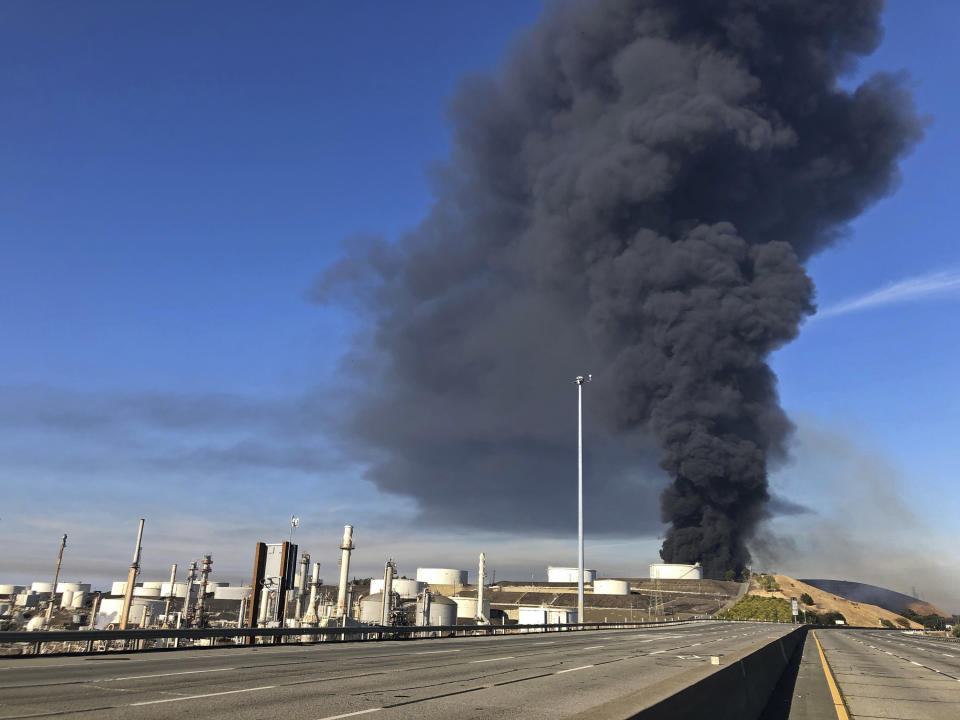 Interstate 80 is closed as a fire at an oil storage facility burns Tuesday, Oct. 15, 2019, in Rodeo, Calif. A fire burning at NuStar Energy LP facility in Crockett, Calif., in the San Francisco Bay Area prompted a hazardous materials emergency that led authorities to order the residents of two communities, including Rodeo, to stay inside with all windows and doors closed. Contra Costa Fire Department spokesman Steve Hill said that an hour into battling the blaze, firefighters seemed to be making progress and were continuing to keep adjacent tanks cooled with water. (AP Photo/Ben Margot)