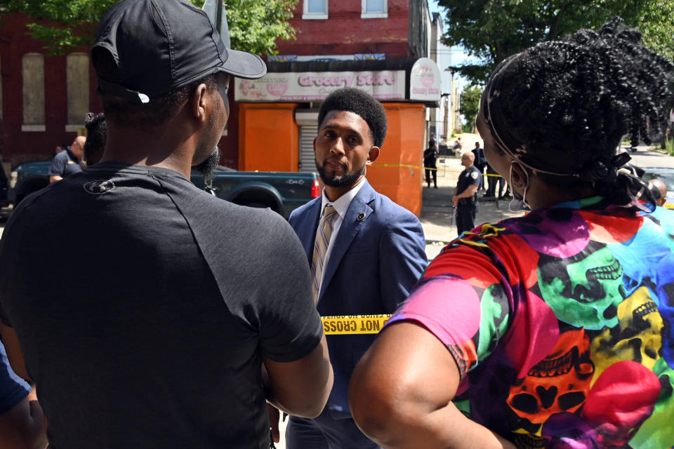 Baltimore Mayor Brandon Scott arrives at the scene where police investigate a shooting, Wednesday, June 16, 2021, in Baltimore. One person was killed and five others were wounded Wednesday when gunmen walked up a street and opened fire on a Baltimore block from an intersection, the city's police commissioner said. (Kim Hairston/The Baltimore Sun via AP)