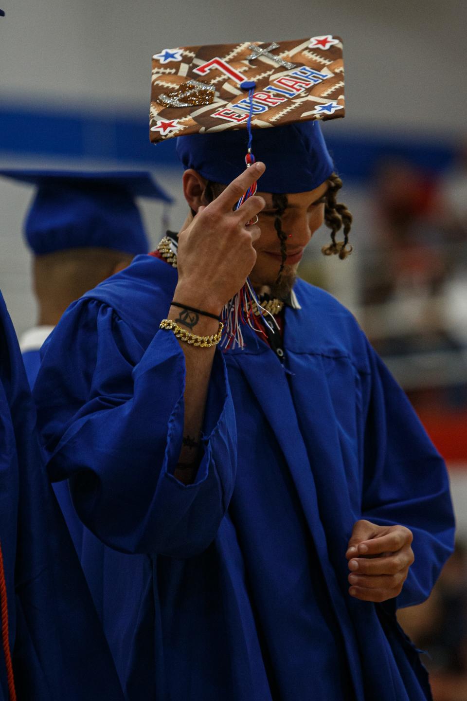 Mount Pleasant High School graduation takes place in Mount Pleasant, Tenn. on May 19, 2023. Football player Euriah Archibald adjusts the tassel on his graduation hat at the ceremony in the school gym.