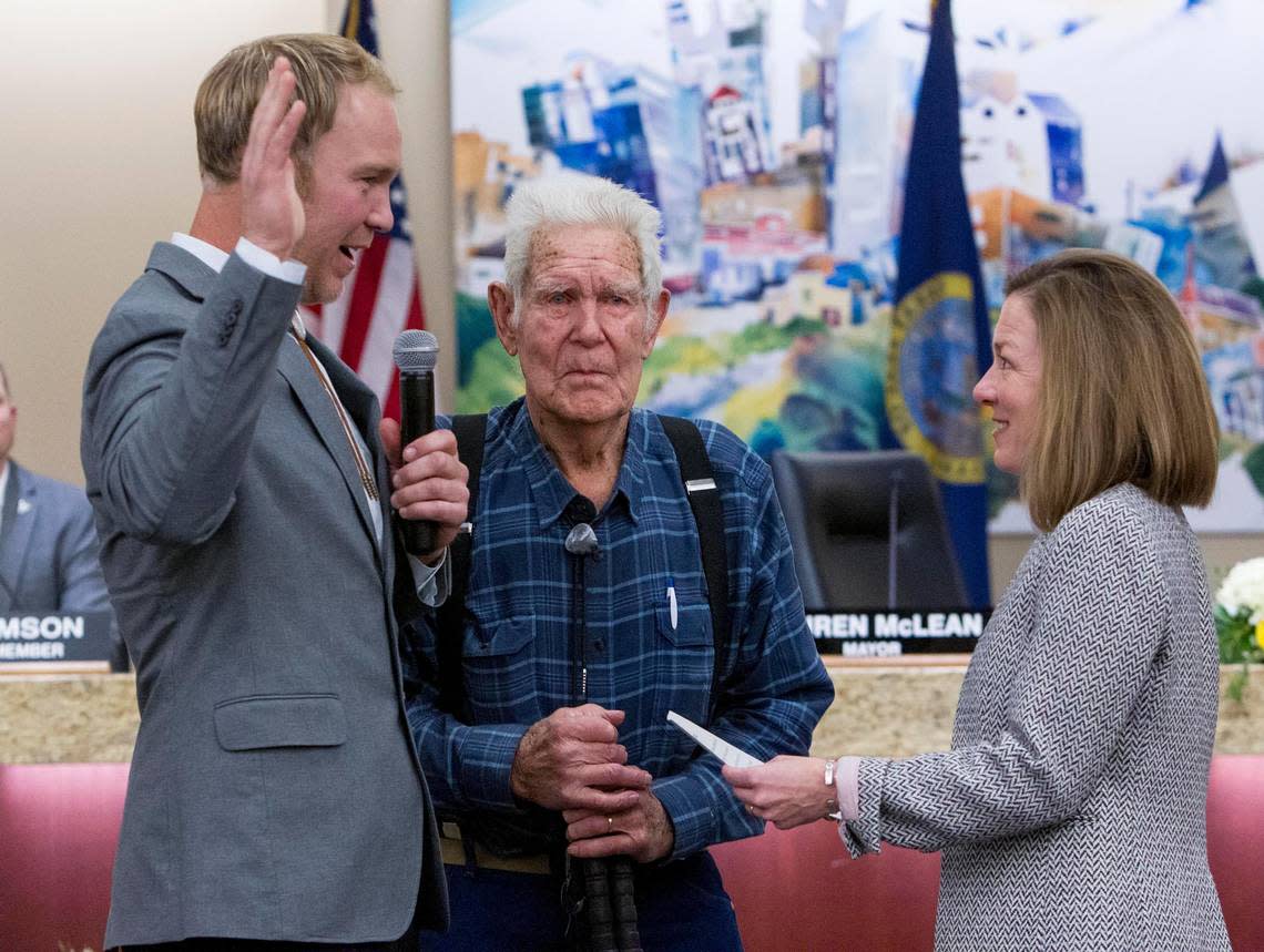 Jimmy Hallyburton, left, with grandfather Al Larson, center, was sworn in as a new member of the Boise City Council by Mayor Lauren McLean in 2020. He plans to run for reelection this fall. Darin Oswald/doswald@idahostatesman.com