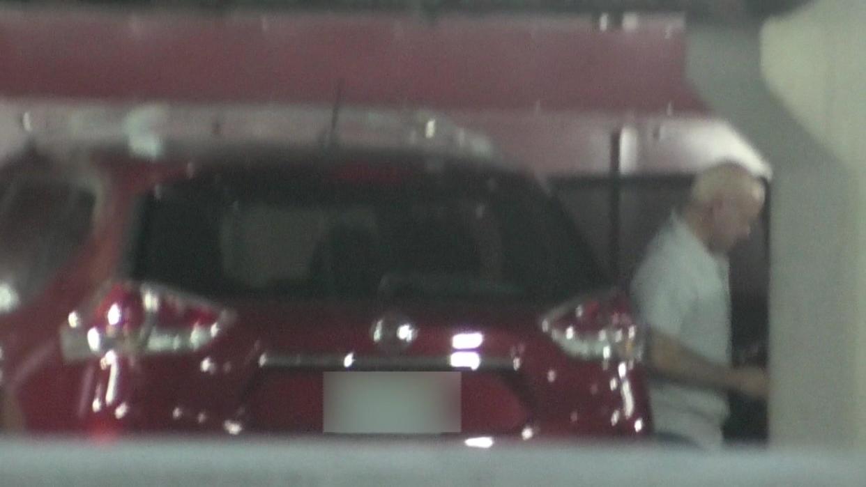 The women followed and videotaped Robert Telles, pictured leaving the back seat of the car of an alleged lover - a subordinate - at a parking garage where the suspected trysts took place.  Both Telles and his alleged lover denied they were having an affair. / Credit: Aleisha Goodwin