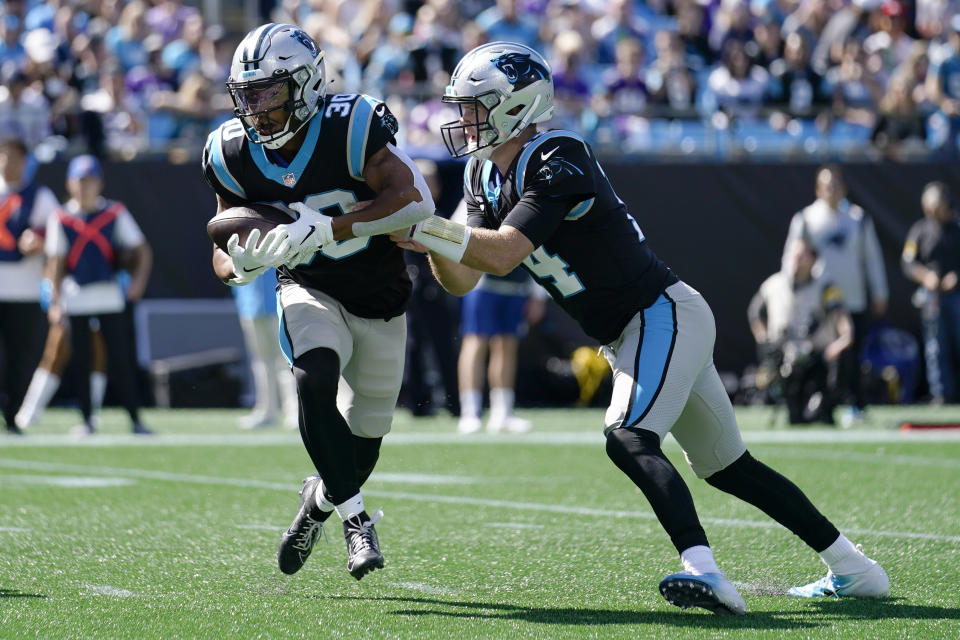 Carolina Panthers running back Chuba Hubbard (30) takes the handoff from Carolina Panthers quarterback Sam Darnold against the Minnesota Vikings during the first half of an NFL football game, Sunday, Oct. 17, 2021, in Charlotte, N.C. Hubbard ran for a touchdown on the play. (AP Photo/Gerald Herbert)