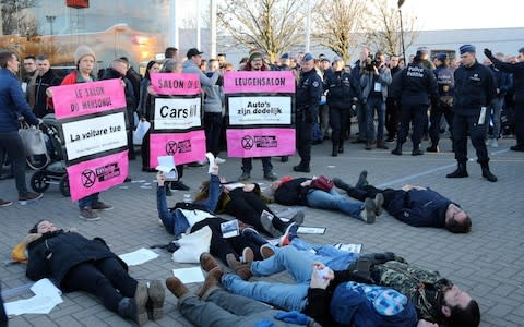 Environmental activists during a protest organised by Extinction Rebellion at the Brussels Motor Show in January - Credit: NICOLAS MAETERLINCK/AFP