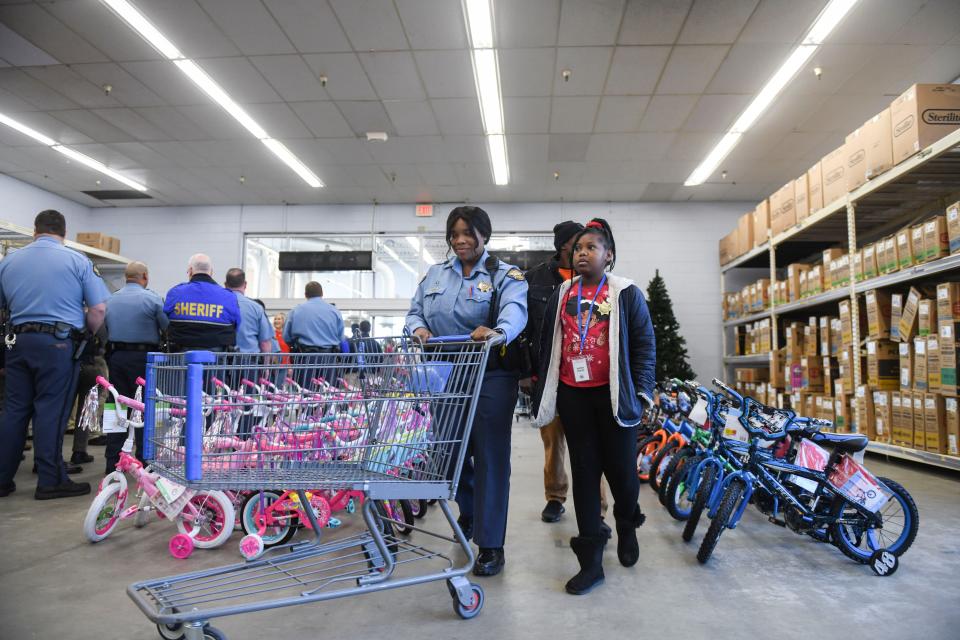Families and deputies walk into Walmart during the Columbia County Sheriff's Office Day with a Deputy at the store on Thursday, Dec. 21, 2023.