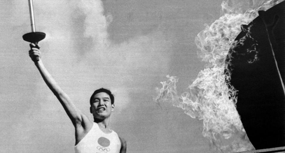 Yoshinori Sakai lights the Olympic flame at the opening of the Olympic Games in 1964