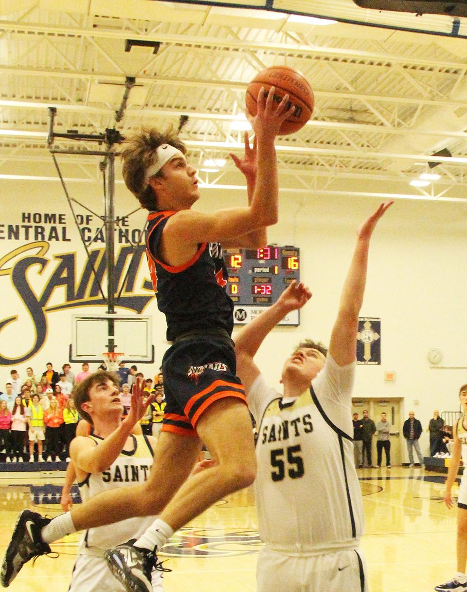 Pontiac's Kerr Bauman tries to take a shot after snaring a lob pass against Central Catholic Friday in Bloomington.