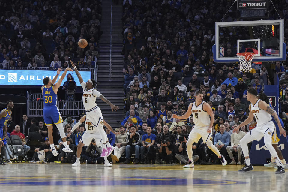 Golden State Warriors guard Stephen Curry (30) shoots a 3-point basket over Denver Nuggets guard Kentavious Caldwell-Pope (5) during the first half of an NBA basketball game Thursday, Jan. 4, 2024, in San Francisco. (AP Photo/Loren Elliott)