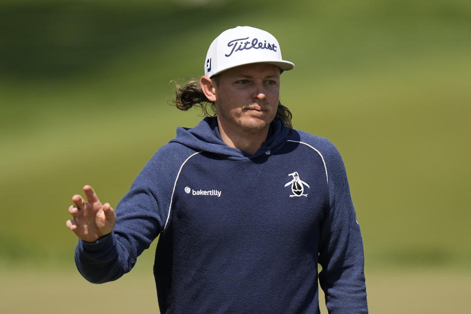 Cameron Smith, of Australia, waves after his putt on the 12th hole during the first round of the PGA Championship golf tournament at Oak Hill Country Club on Thursday, May 18, 2023, in Pittsford, N.Y. (AP Photo/Eric Gay)