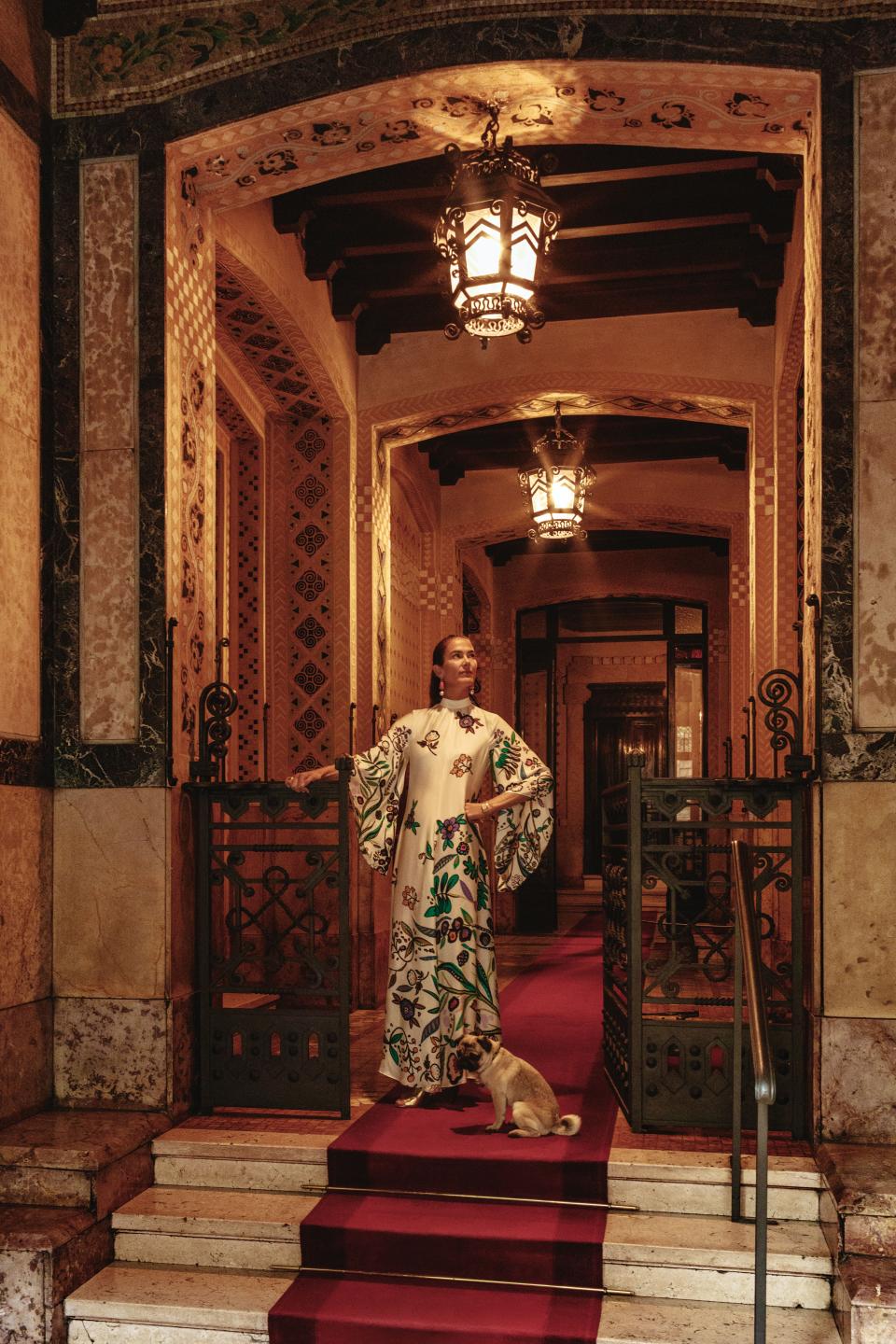 J.J. Martin, wearing a La DoubleJ dress, and her pug, pepper, in the entrance of her 1910 apartment building.