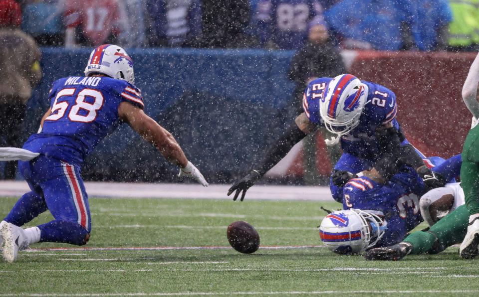 Bills Matt Milano and Jordan Poyer pounce on a fumble by Jets running back Michael Carter.  Milano came up with the ball. 