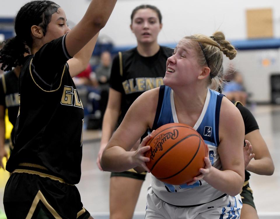 Louisville's Brooke Haren spots the basket around GlenOak's Nakahleigh Gadison to hit for two in the second quarter of GlenOak at Louisville girls basketball. Saturday, December 9, 2023.